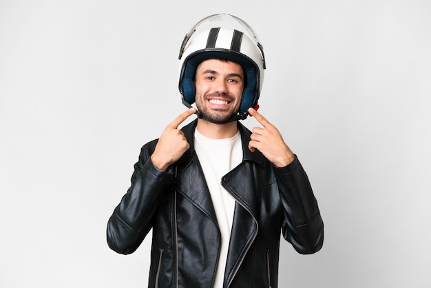 Young caucasian man with a motorcycle helmet over isolated white background giving a thumbs up gesture