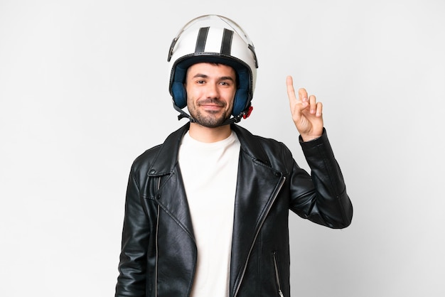 Young caucasian man with a motorcycle helmet over isolated white background pointing up a great idea