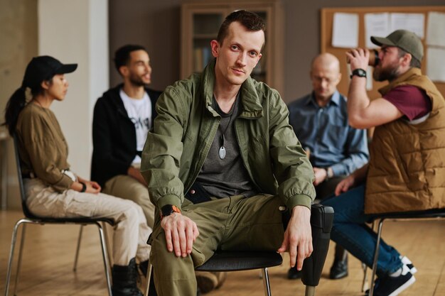 Young caucasian man with post traumatic syndrome sitting in front of camera