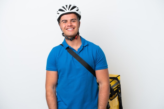 Young caucasian man with thermal backpack isolated on white background laughing