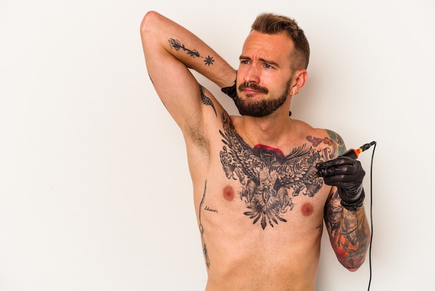 Young caucasian man without t-shirt isolated on white background  touching back of head, thinking and making a choice.