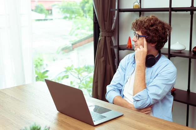 Young Caucasian Man work from home on laptop and connect online to office indoor for remote internet workplace Young Adult male is freelance work smart on notebook sit in working room copy space