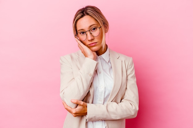 Young caucasian mixed race business woman isolated on pink who is bored, fatigued and need a relax day.