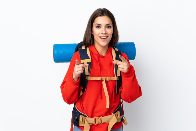 Young caucasian mountaineer girl with a big backpack