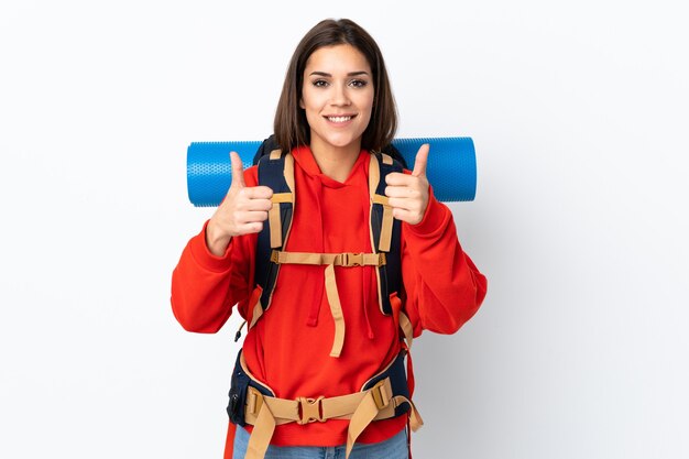 Young caucasian mountaineer girl with a big backpack