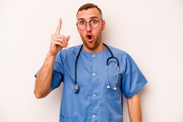 Young caucasian nurse man isolated on white background having some great idea concept of creativity