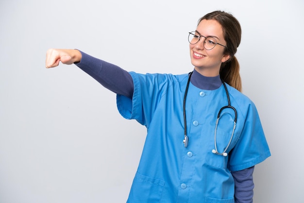 Young caucasian nurse woman isolated on white background giving a thumbs up gesture