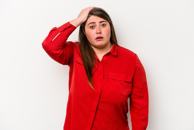 Young caucasian overweight woman isolated on white background being shocked, she has remembered important meeting.