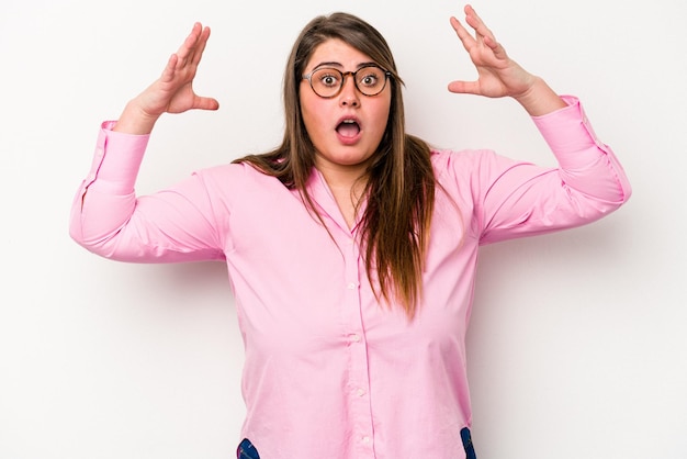 Young caucasian overweight woman isolated on white background celebrating a victory or success he is surprised and shocked