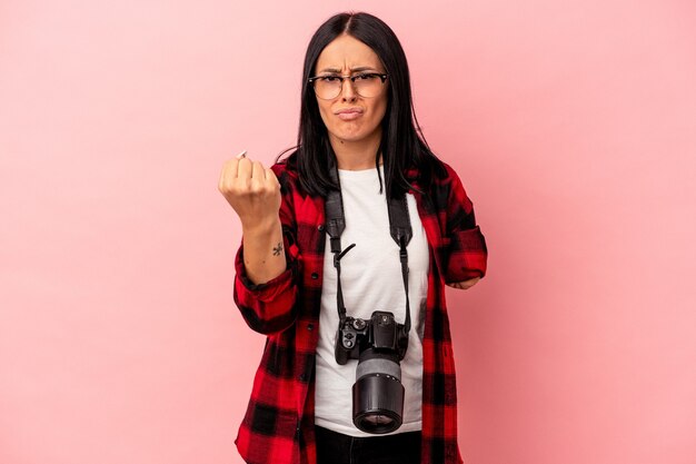 Young caucasian photography woman with one arm isolated on pink background showing fist to camera, aggressive facial expression.