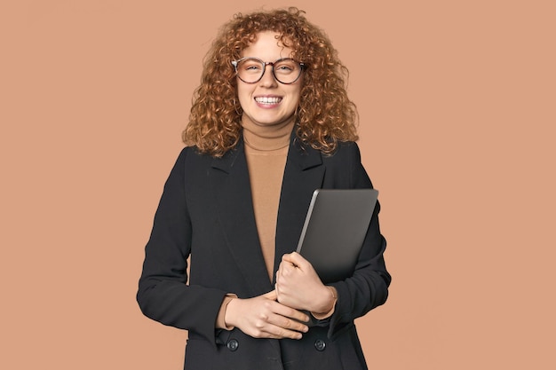 Young Caucasian redhead businesswoman with laptop happy