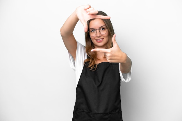 Young caucasian restaurant waiter woman isolated on white background focusing face Framing symbol