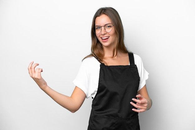 Young caucasian restaurant waiter woman isolated on white background making guitar gesture