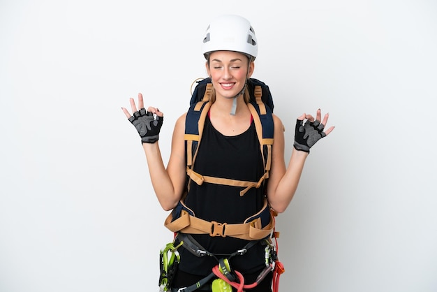 Young caucasian rock climber woman isolated on white background in zen pose