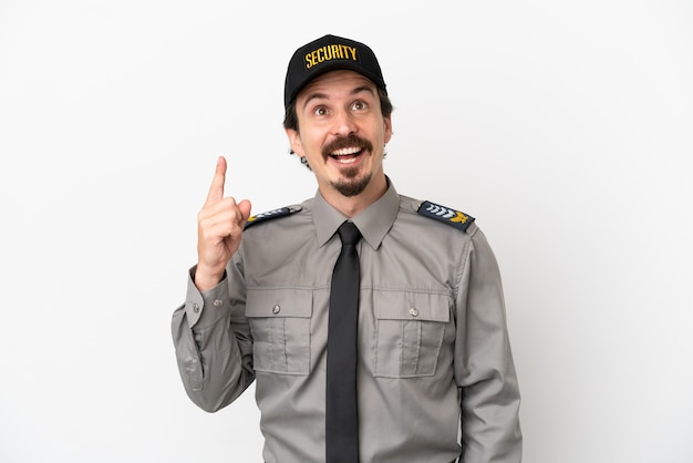 Young caucasian security man isolated on white background pointing up and surprised