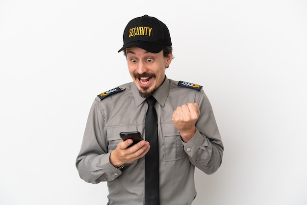 Young caucasian security man isolated on white background surprised and sending a message