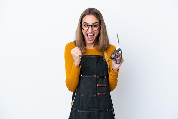 Young caucasian sewing box woman isolated on white background celebrating a victory in winner position