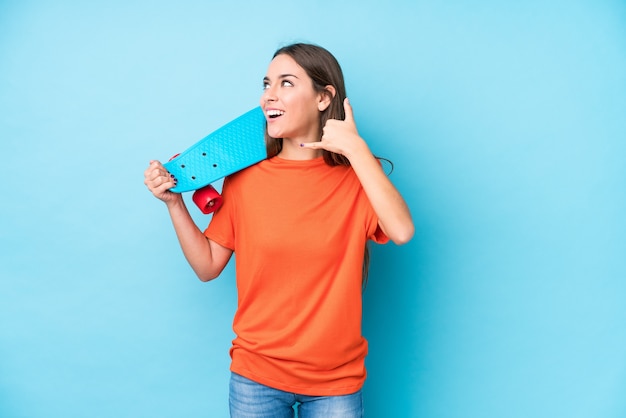 Young caucasian skater woman isolated showing a mobile phone call gesture with fingers.