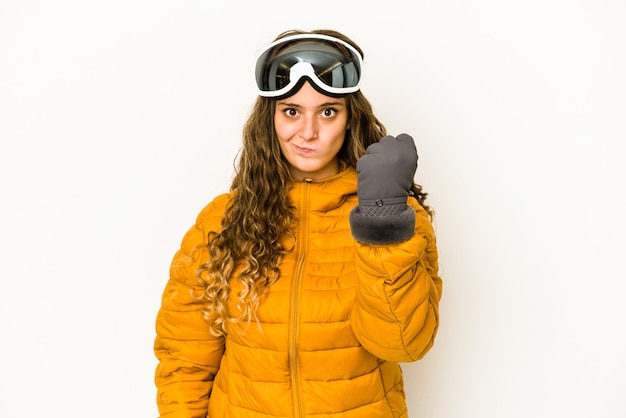 Young caucasian snowboarder woman isolated showing fist to camera, aggressive facial expression.