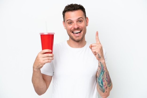 Young caucasian soda holding soda isolated on white background pointing up a great idea