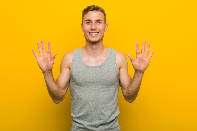 Young caucasian sport man showing number ten with hands.