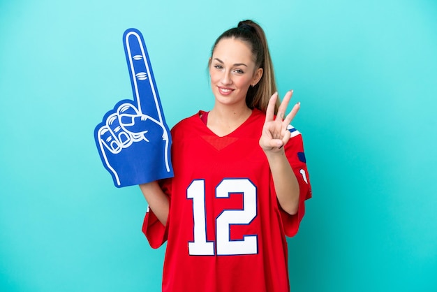 Young caucasian sport woman isolated on blue background happy and counting three with fingers