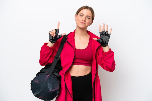 Young caucasian sport woman isolated on white background counting seven with fingers