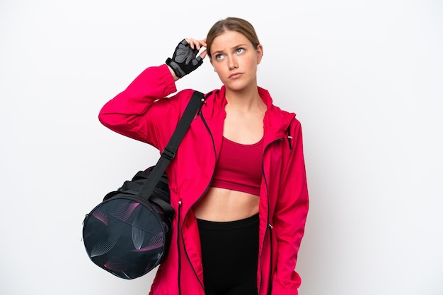 Young caucasian sport woman isolated on white background having doubts and with confuse face expression