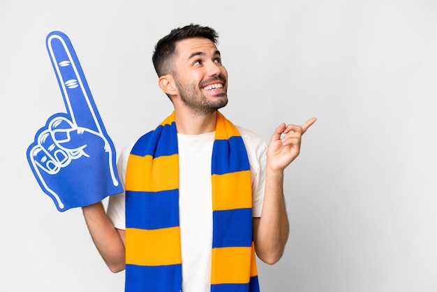 Young caucasian sports fan man over isolated white background intending to realizes the solution while lifting a finger up