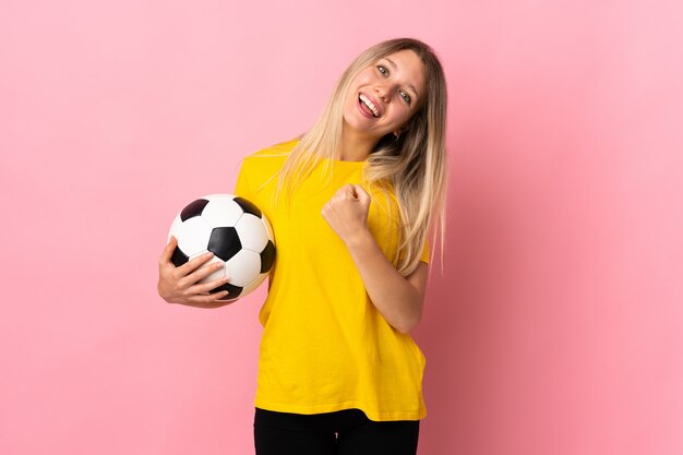 Young caucasian sporty woman over pink wall