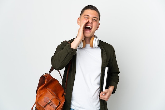 Young caucasian student man isolated on white background shouting with mouth wide open