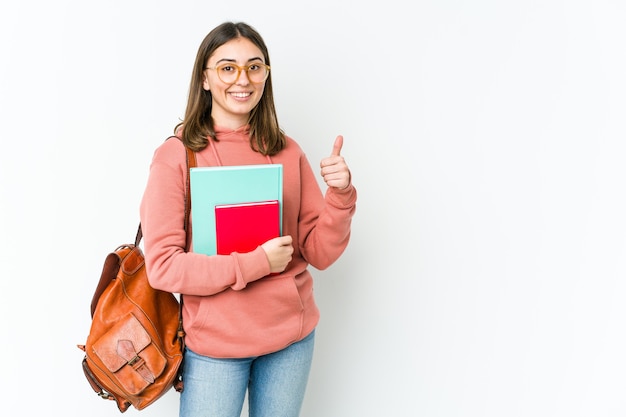 Donna giovane studente indoeuropeo isolata sul muro bianco sorridendo e alzando il pollice