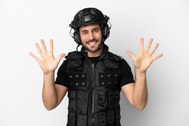 Young caucasian swat isolated on white background counting ten with fingers