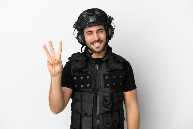 Young caucasian swat isolated on white background happy and counting three with fingers