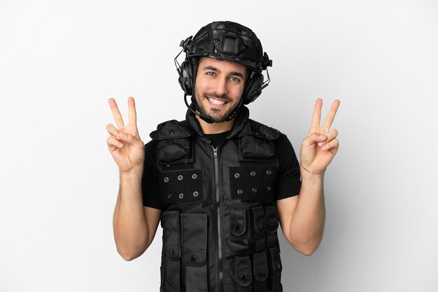Young caucasian swat isolated on white background showing victory sign with both hands