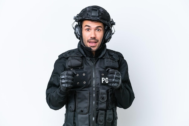 Young caucasian SWAT man isolated on white background celebrating a victory in winner position