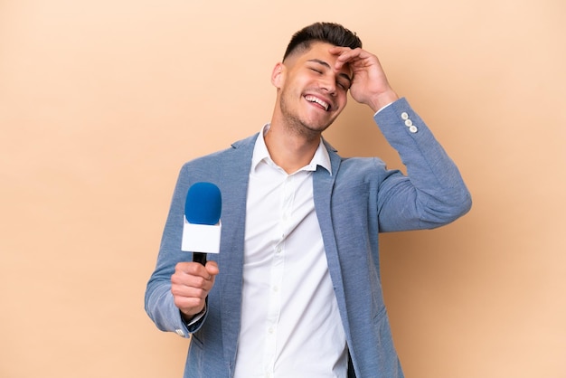 Young caucasian TV presenter man isolated on white background smiling a lot