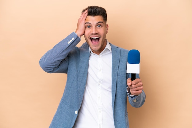 Young caucasian TV presenter man isolated on white background with surprise expression