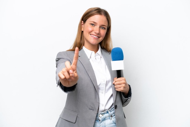 Young caucasian tv presenter woman isolated on white background showing and lifting a finger