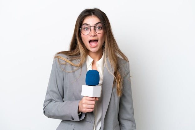 Young caucasian TV presenter woman isolated on white background with surprise facial expression