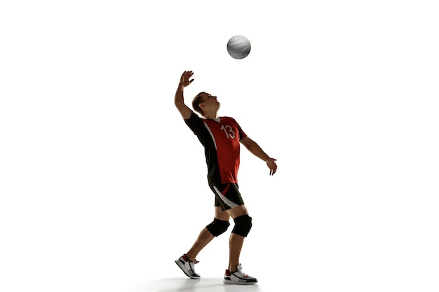 Photo young caucasian volleyball player placticing isolated on white background