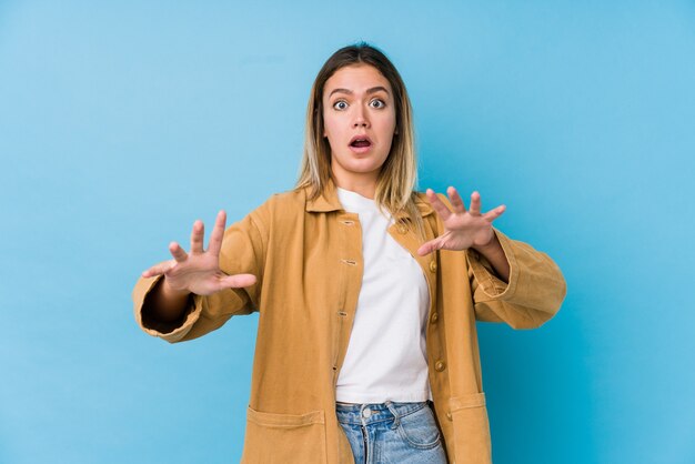 Young caucasian woman being shocked due to an imminent danger