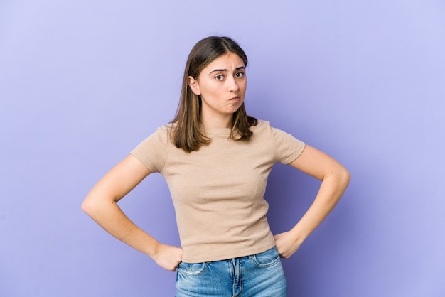 Young caucasian woman confused, feels doubtful and unsure.