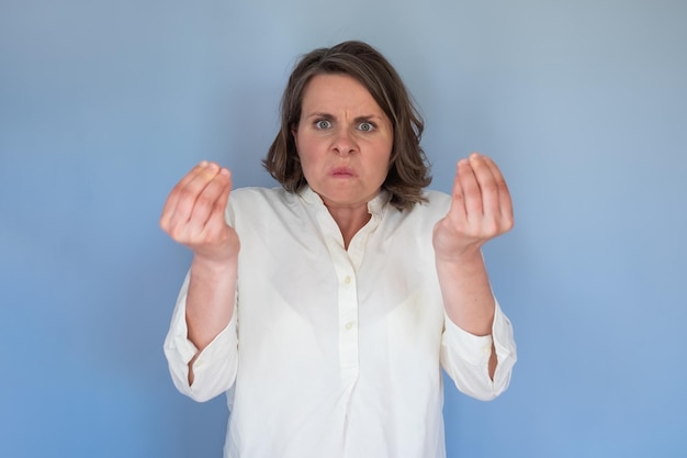 Young caucasian woman doing italian gesture with hand and fingers arguing having conflict