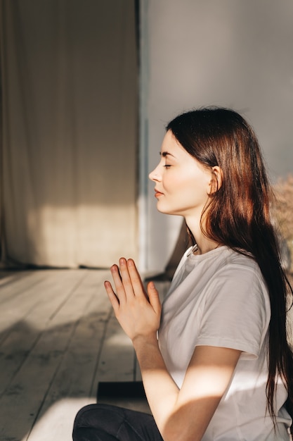 Young caucasian woman doing yoga at home