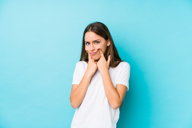 Young caucasian woman doubting between two options.