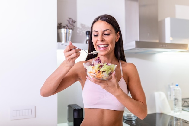 Young caucasian woman eating salad Healthy Diet Beautiful Smiling Woman Eating Fresh Organic Vegetarian Salad Healthy Eating Food And Lifestyle Concept Health Beauty