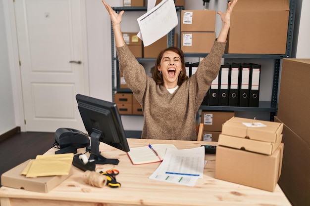 Young caucasian woman ecommerce business worker throwing documents at office