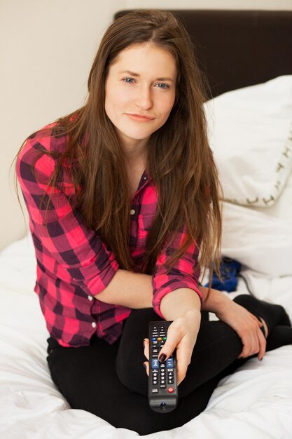 Young caucasian woman emotionally watching TV with console