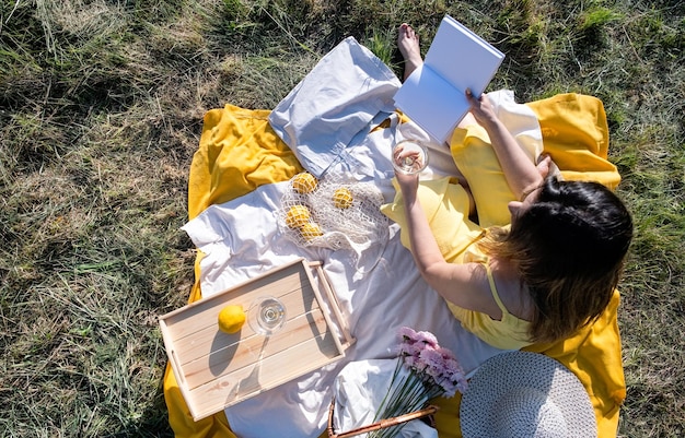 Young caucasian woman enjoying the flowering of an apple trees